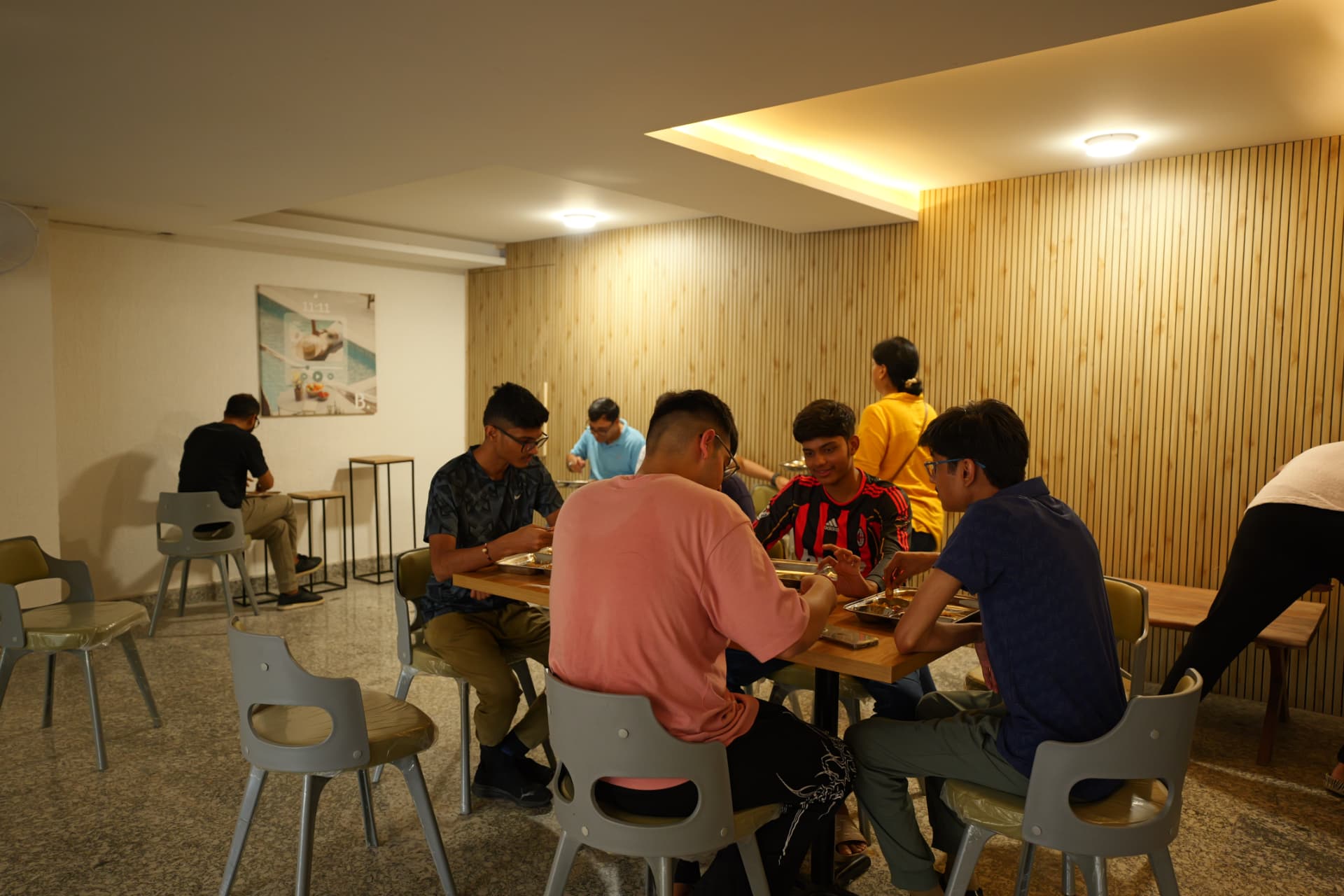 Students unwinding in the hostel common area in the evening