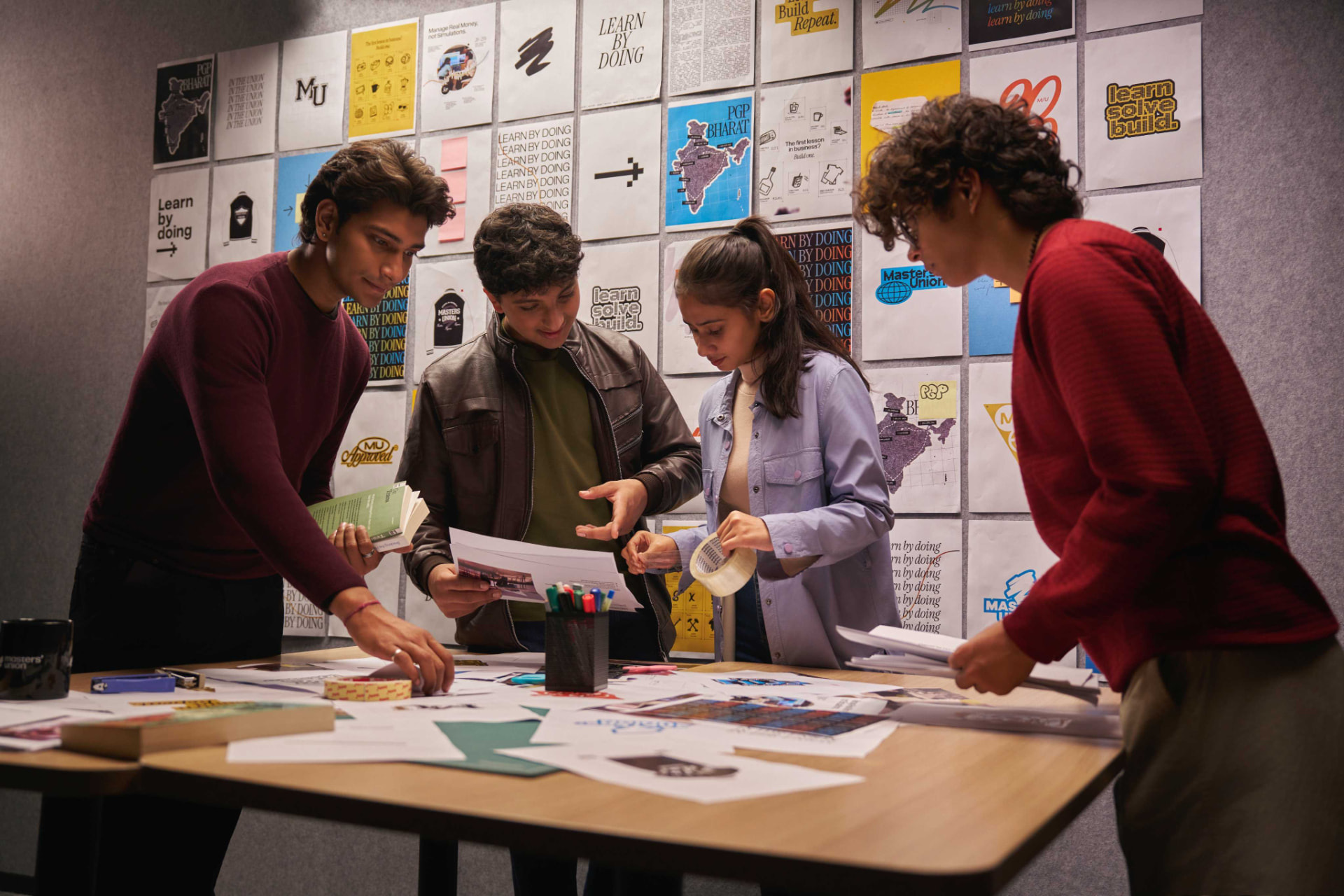 Students working together around a project table at Masters' Union